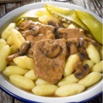Braised pork loin with mushroom gravy served over potato gnocchi