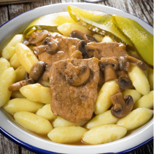 Braised pork loin with mushroom gravy served over potato gnocchi