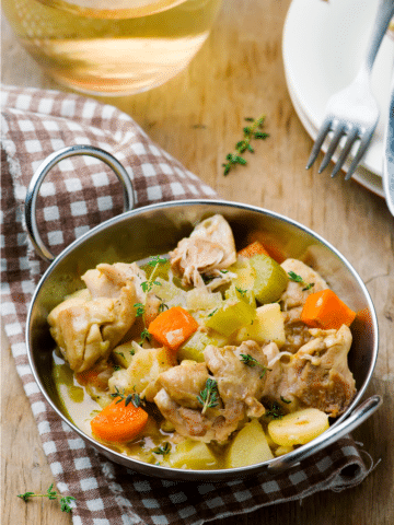 Crockpot chicken fricassee with tender chicken thighs, potatoes, carrots and celery