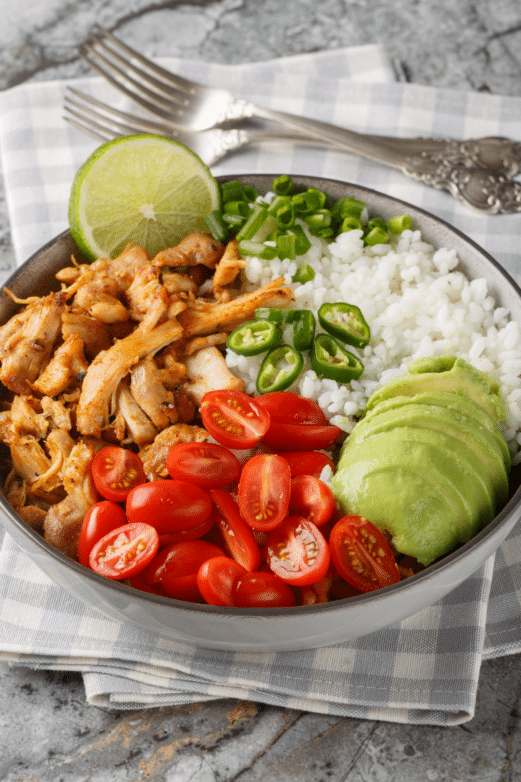Crock Pot crispy pork carnitas with rice, tomatoes and jalapeños