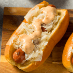 Kielbasa sausage on a bun topped with sauerkraut