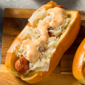 Kielbasa sausage on a bun topped with sauerkraut