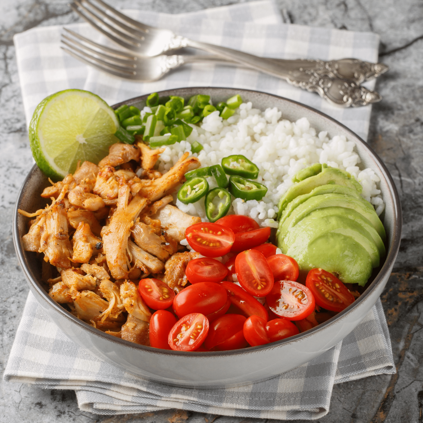 Leftover pork carnitas bowl with rice avocado tomatoes jalapeños and lime