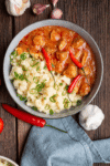 A bowl of creamy pork stew with tender pork in a rich, savory sauce.