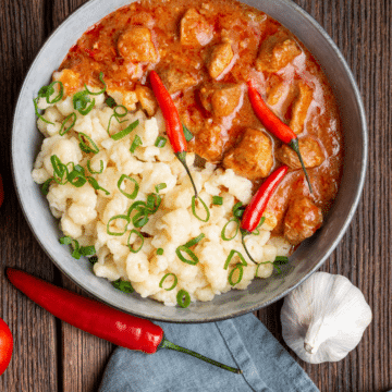 A bowl of creamy pork stew with tender pork in a rich, savory sauce.