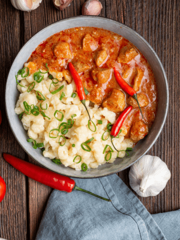 A bowl of creamy pork stew with tender pork in a rich, savory sauce.