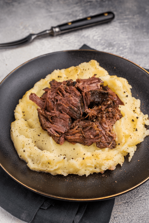 Tender roast beef served over creamy mashed potatoes