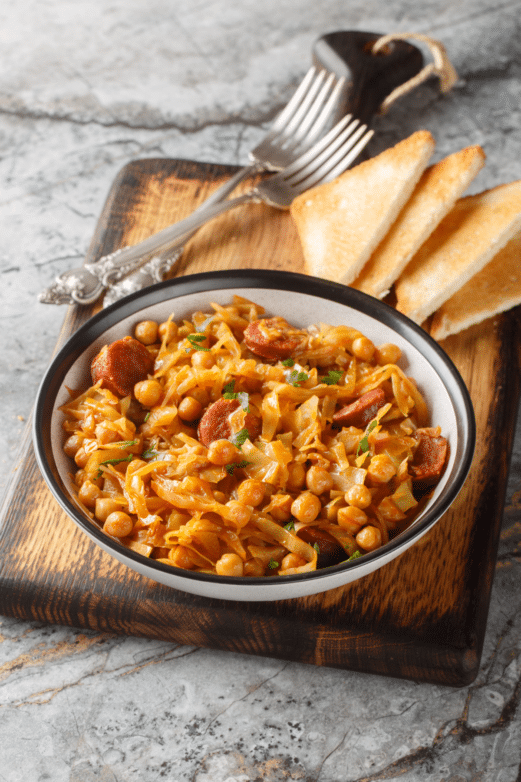 Slow cooker cabbage sausage soup served with toasted bread